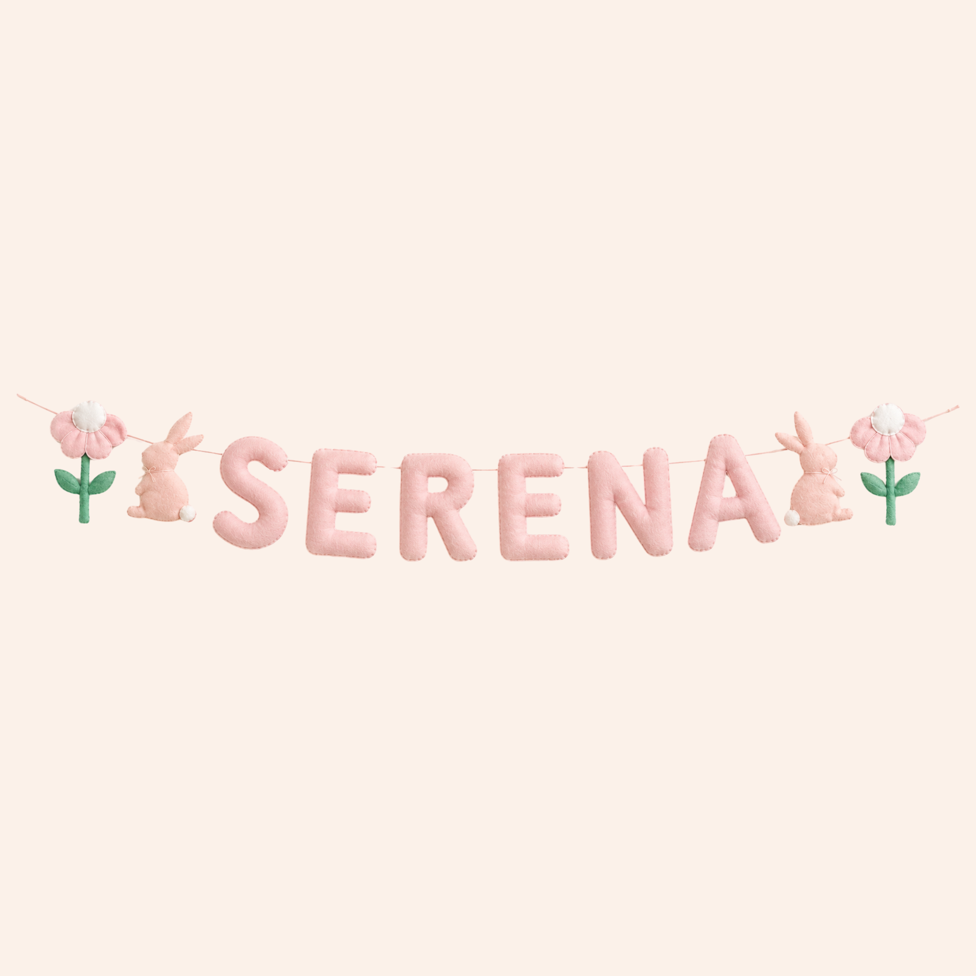 Decorative name garland with the name 'SERENA' on a pink background with floral and bunny elements.