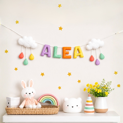 Colorful name garland with 'ALEA' on a shelf with toys and decor