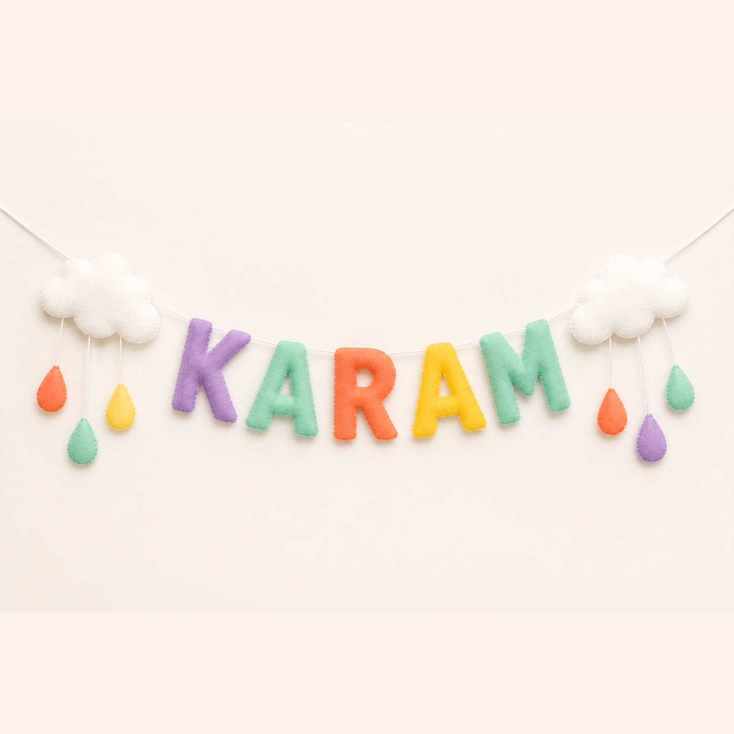 Colorful 'Karam' banner with raindrop name garland on a white background