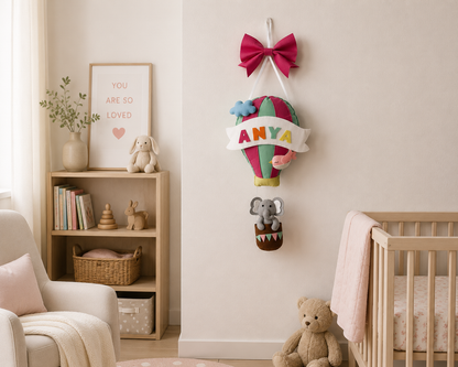 Children's room with a crib, bookshelf, and decorative wall hanging.