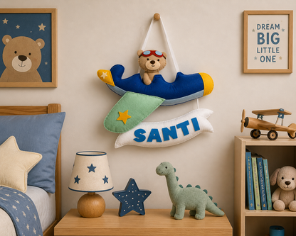 Children's room with teddy bear decorations, books, and toys on a shelf.