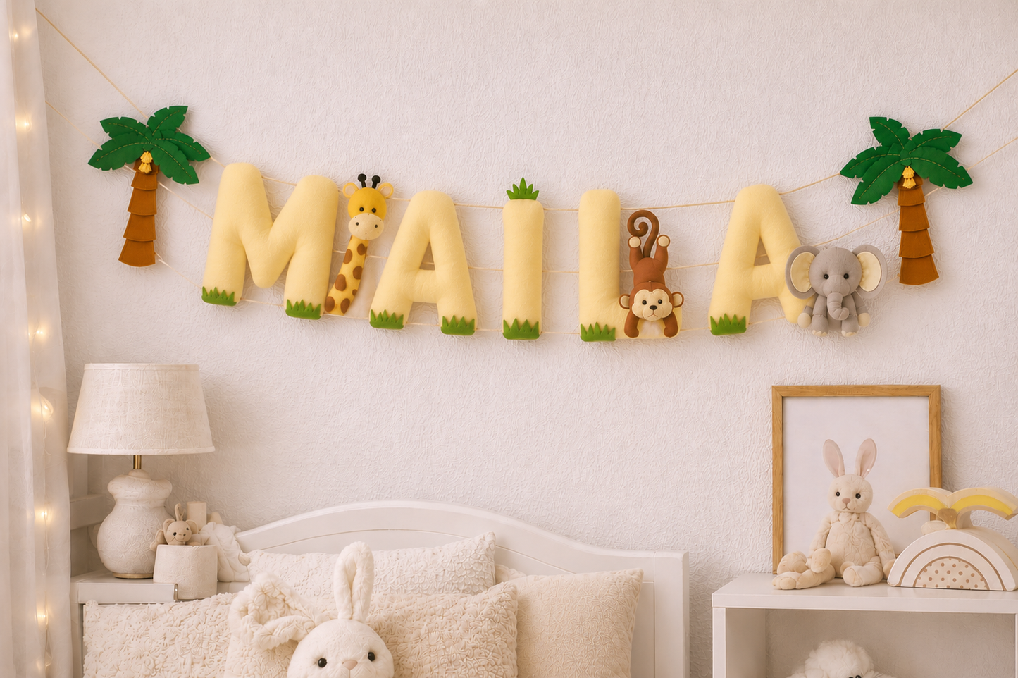Children's room with decorative name bunting spelling 'MAIA' on the wall, surrounded by animal-themed decorations.