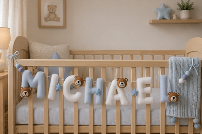 Nursery room with wooden crib, teddy bear decorations, and 'Michael' name garland.