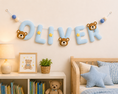 Children's room with personalized name banner, teddy bear decor, and books.