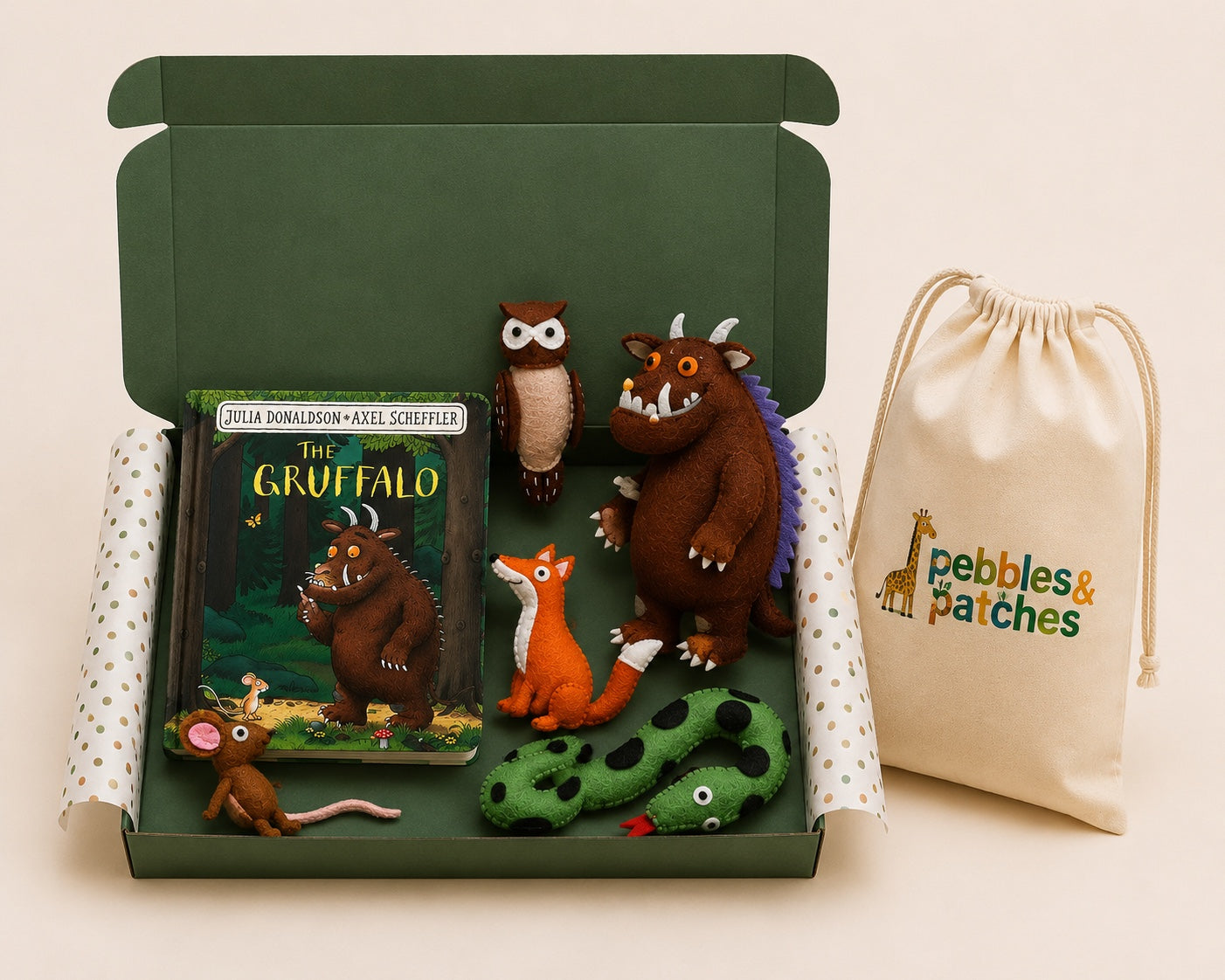 Gruffalo-themed children's gift set with book, plush toys, and drawstring bag on a beige background