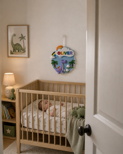 Baby sleeping in a crib with a decorative felt toy above, in a room with a lamp and books.