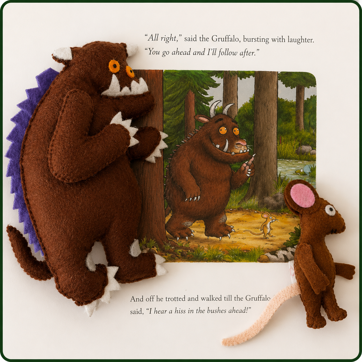Plush toys of a bear and a mouse with a scene from 'The Gruffalo' book.